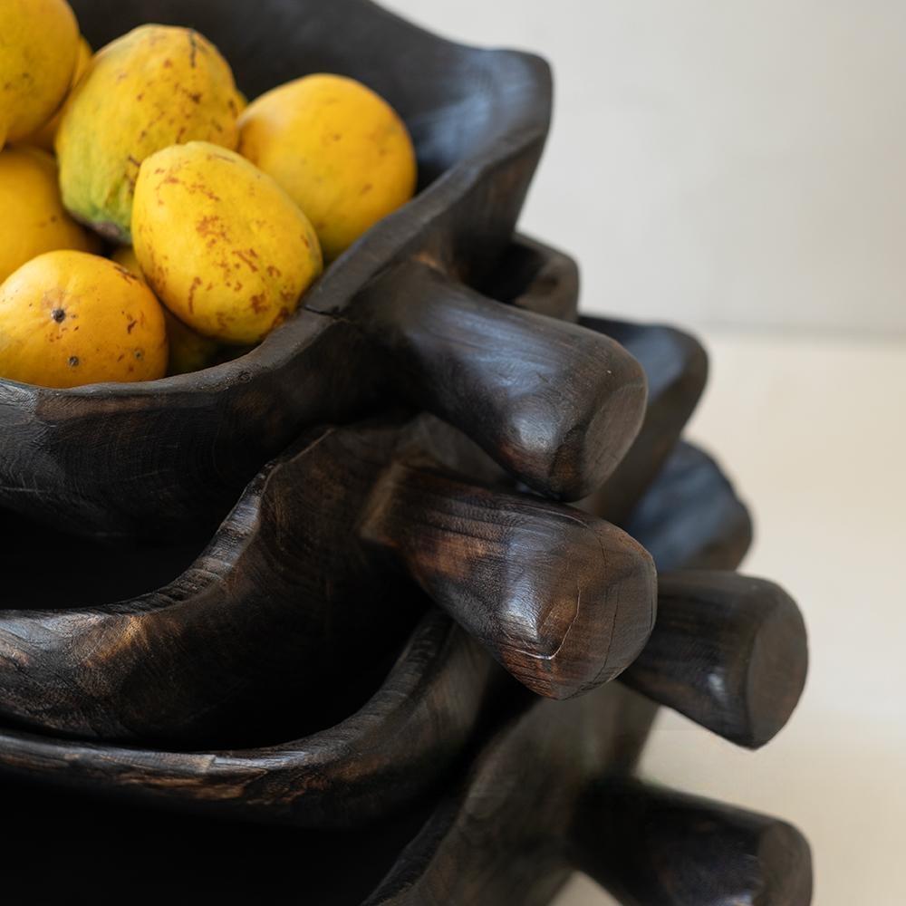 A close-up of yellow guavas in a Camphor Wood Fruit Handled Tray (14 x 9 x 11 in), with two similar empty trays stacked underneath, all with elongated handles.